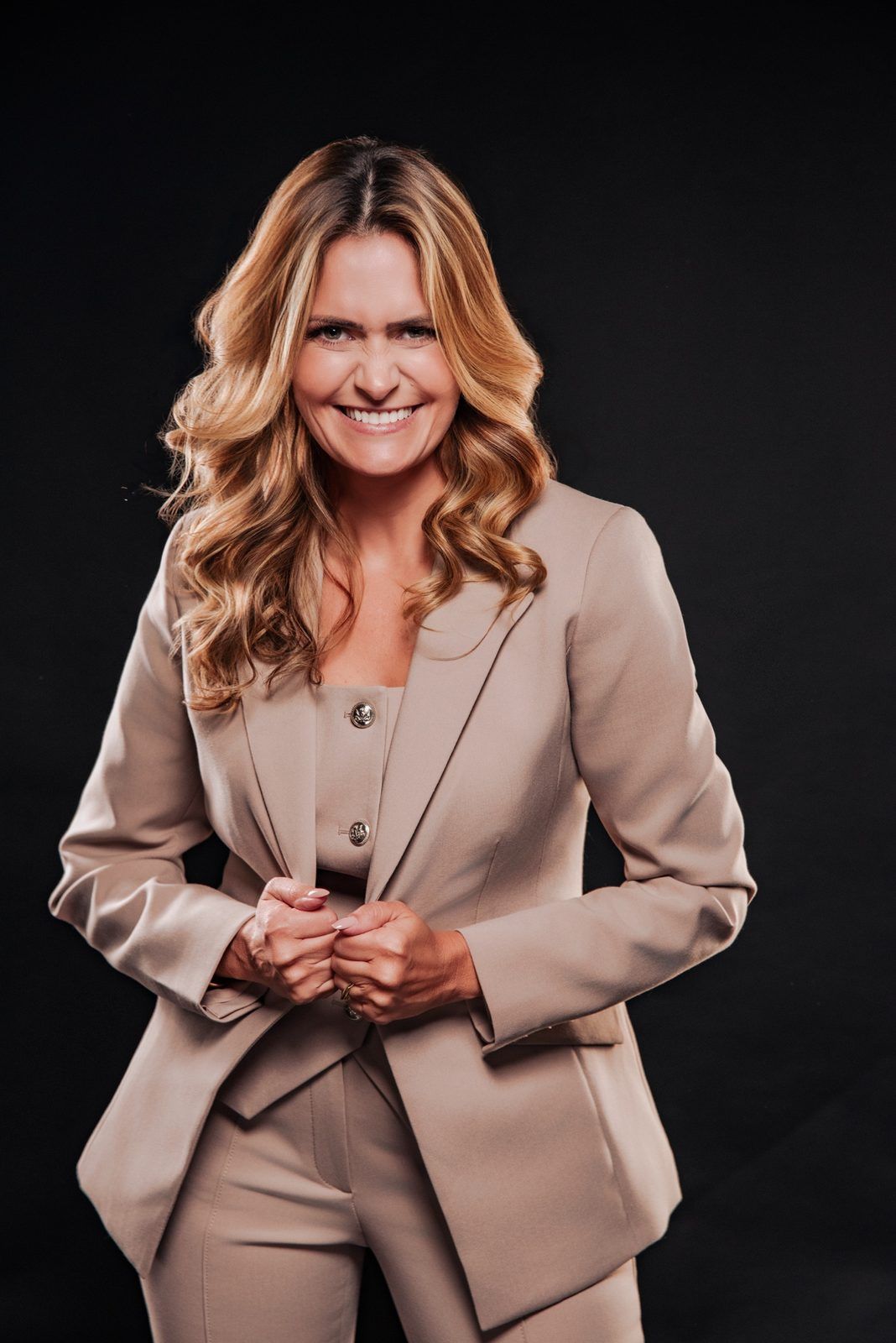 Giselle Gartzke smiling in a beige suit